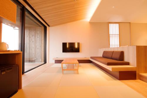 a living room with a couch and a table at 山人 Oga in Oga