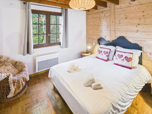 a bedroom with a large bed and a chair at Le Haut de Sauté Vue Imprenable à Bussang in Bussang