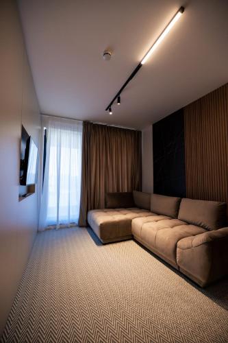 a living room with a couch and a window at Senior Apartment with Lake View in Eforie Nord