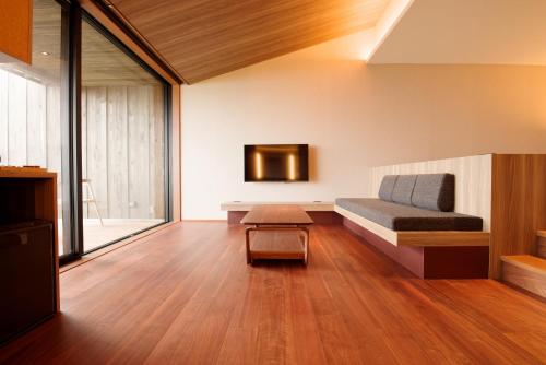 a room with a bed and a tv on the wall at 山人 Oga in Oga