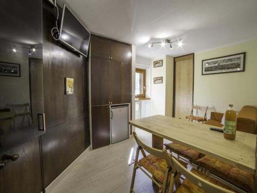 a kitchen and dining room with a wooden table at Apartment Breuil-Cervinia near Ski Lift in Breuil-Cervinia