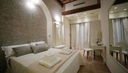 a bedroom with a bed with two towels on it at Hotel Renaissance in Florence