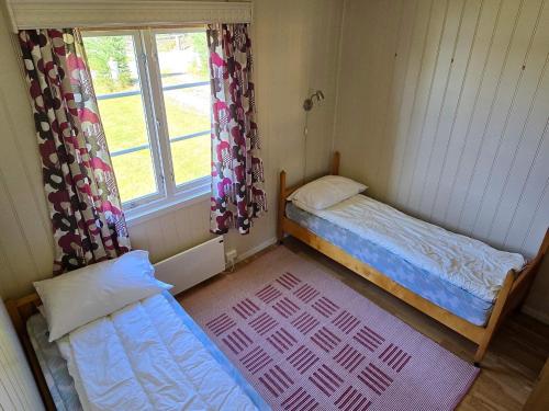 two beds in a room with a window at 6 person holiday home in Osen in Vika