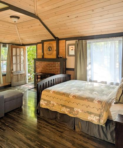a bedroom with a bed and a fireplace at Hinckleys Dreamwood Cottages in Bar Harbor