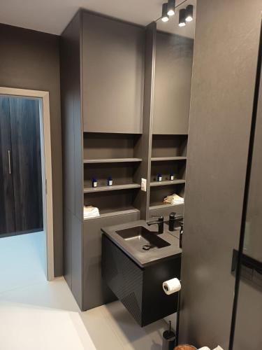 a bathroom with a black sink and a mirror at delux studio in Timişoara