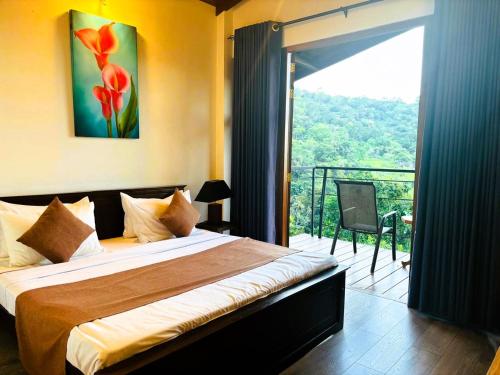 a bedroom with a bed and a balcony with a view at Benjamin Cottage Haputale in Haputale