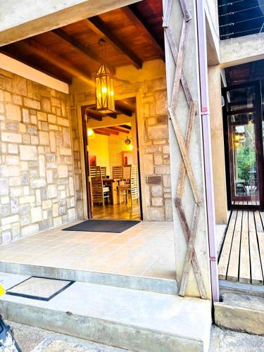 a house with a door open to a dining room at Benjamin Cottage Haputale in Haputale