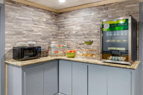 a kitchen with a microwave and a refrigerator at Quality Inn & Suites Raleigh Durham Airport in Morrisville