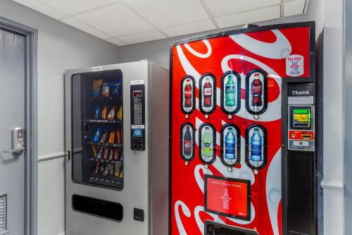 a cocacola soda machine is next to a vending machine at Quality Inn & Suites Raleigh Durham Airport in Morrisville