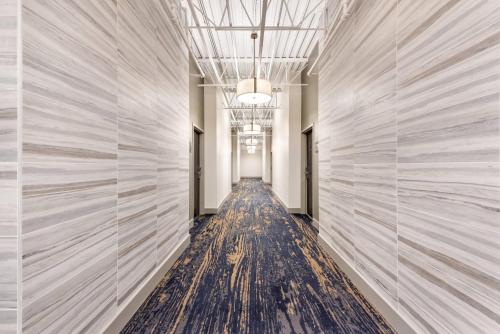 a hallway with white walls and a long aisle at The Federal Hotel Downtown Carson City, an Ascend Collection Hotel in Carson City