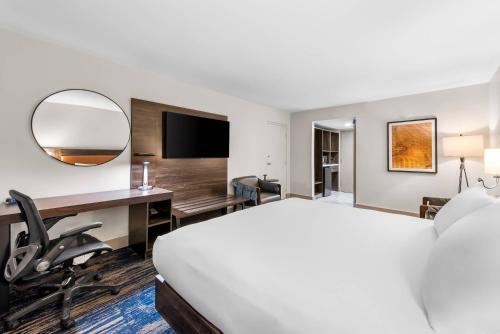a hotel room with a bed and a desk at The Federal Hotel Downtown Carson City, an Ascend Collection Hotel in Carson City
