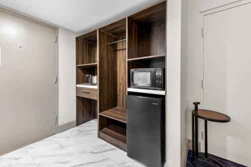 a kitchen with a black refrigerator and a microwave at The Federal Hotel Downtown Carson City, an Ascend Collection Hotel in Carson City