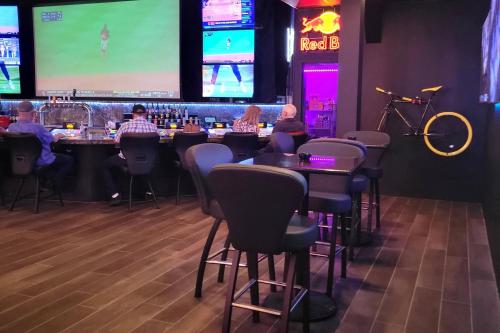 a group of people sitting at a bar in a restaurant at The Federal Hotel Downtown Carson City, an Ascend Collection Hotel in Carson City