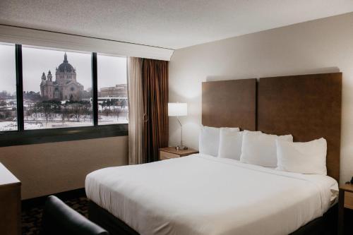 a hotel room with a large bed and a window at Radisson Hotel St Paul Downtown in Saint Paul