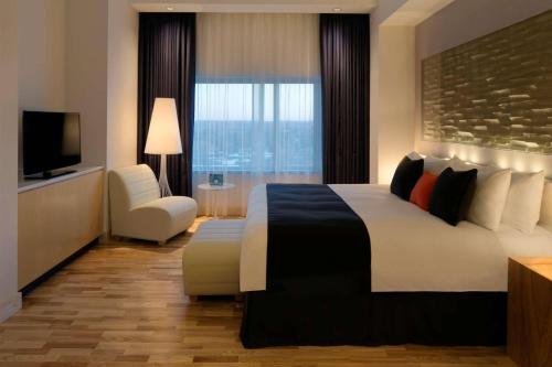 a hotel room with a large bed and a television at Radisson Blu Mall of America in Bloomington