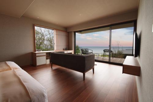a bedroom with a bed and a view of the ocean at 山人 Oga in Oga