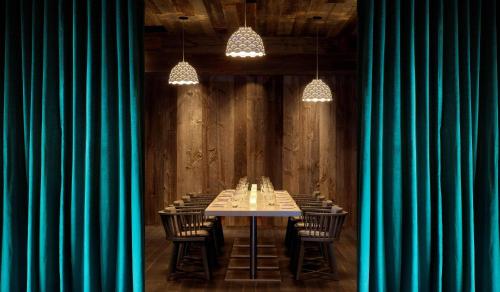 a long table in a room with green curtains at Radisson Blu Mall of America in Bloomington