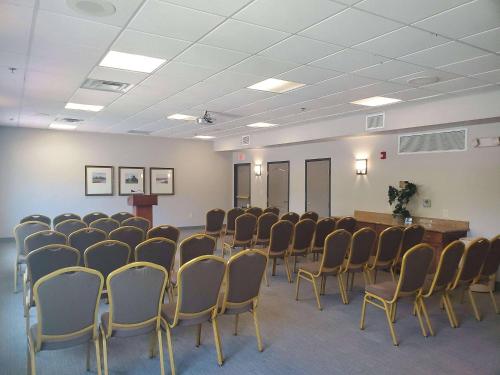 a room with a bunch of chairs and a podium at Country Inn & Suites by Radisson, Rocky Mount, NC in Rocky Mount