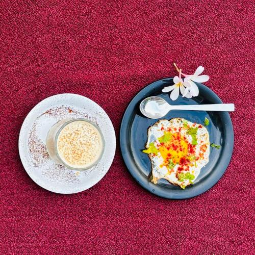 a plate of food and a cup of coffee on a table at Anant Villa & Resorts in Nagaon