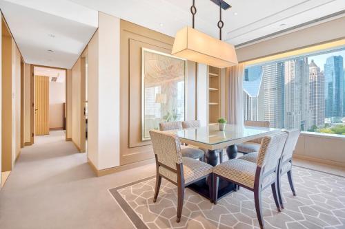 a dining room with a table and chairs and a window at IFC Residence in Shanghai