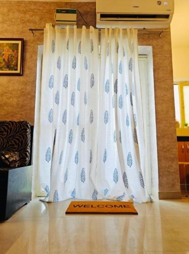 a white curtain with a wooden board on the floor at Luxury Rose hotel in Mussoorie
