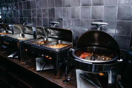 a row of trays of food on a buffet at Hotel Fessla in Kostanay
