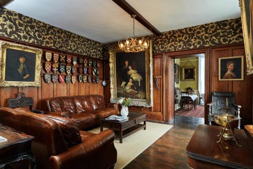 a living room with leather furniture and paintings on the walls at The Castle in Castlehaven