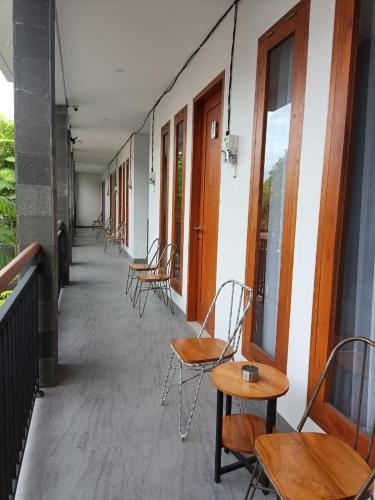 a row of chairs and tables on a balcony at Rauda Living Space Syariah in Pasuruan