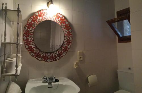 a bathroom with a sink and a mirror on the wall at Mas Pardas in Santa Pau