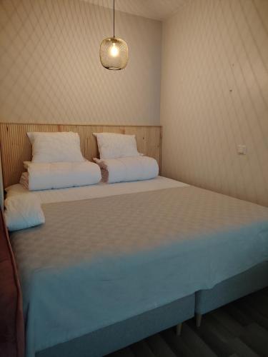 a bed in a room with two pillows on it at Rauhallinen majoitus parvekkeella in Joensuu