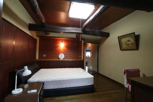 a bedroom with a bed and a skylight at Big loghouse - Vacation STAY 13327 in Ogano