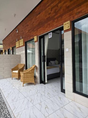 a room with a bed and a patio at Kerti Beach Bungalow and Restaurant in Padangbai