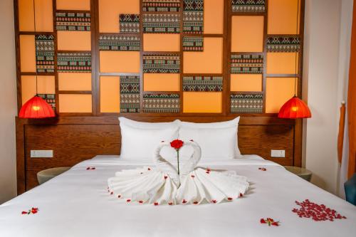 a bedroom with a bed with a flower on it at Lestar Hotel Sapa in Sa Pa