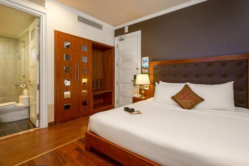 a bedroom with a large bed and a bathroom at Samdi Premium - Near Da Nang International Airport in Da Nang