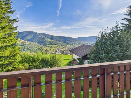a wooden fence with a view of mountains at Le Haut de Sauté Vue Imprenable à Bussang in Bussang
