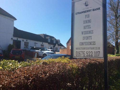 a sign in a yard with a parking lot at Strawberry Bank Hotel, NEC in Meriden