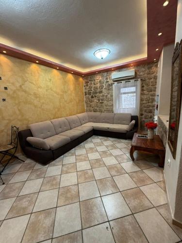 a living room with a couch in a room at Athos Guesthouse in Kotor
