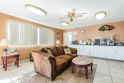 a living room with a couch and a kitchen at Rodeway Inn Prattville I-65 in Prattville