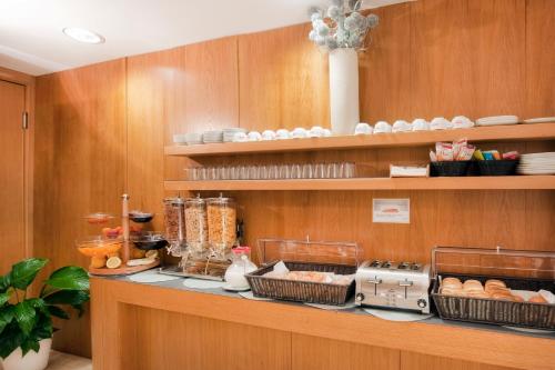 a kitchen with a counter with food on it at Best Western Ars Hotel in Rome