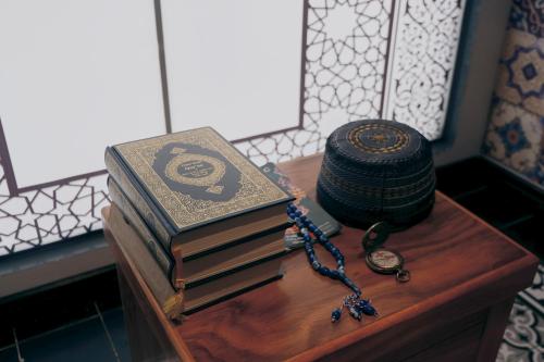 a group of books sitting on a table with a rosary at Catherine Cruise in Ha Long