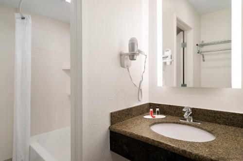 a bathroom with a sink and a mirror at The Kendrick Hotel, an Ascend Collection Hotel in Flagstaff