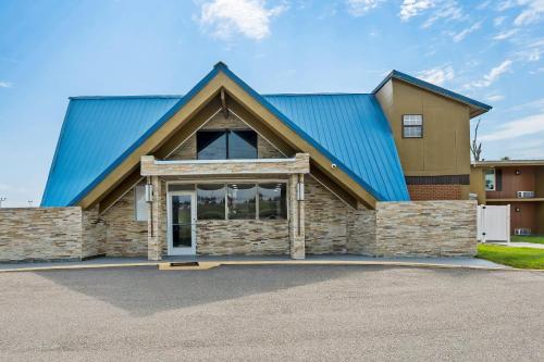 a large building with a blue roof at Econo Lodge Montgomery South I-65 in Montgomery