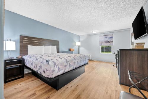 a large bedroom with a bed and a television at Econo Lodge Montgomery South I-65 in Montgomery