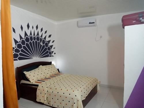 a small bedroom with a bed in a room at Iroko Plage San Pédro in San-Pédro