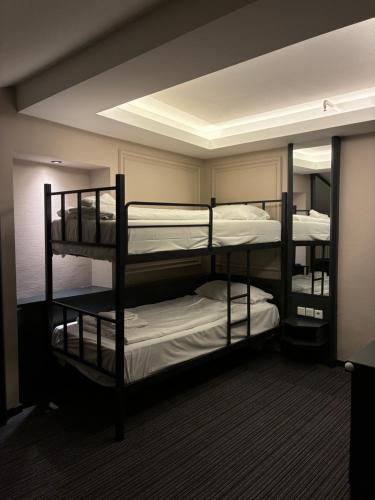 a room with three bunk beds in a room at Hotel Monopol City Centre in Düsseldorf