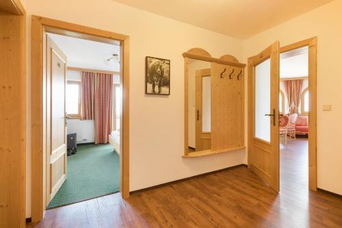a hallway with a door open to a living room at Alpenkönig in Zell am Ziller
