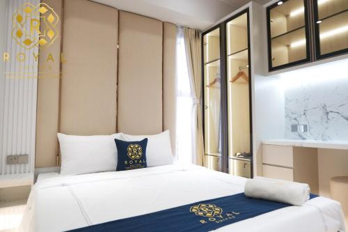 ナゴヤにあるRoyal Suites 2BR - Baloi Apartmentのベッド2台と窓のある寝室