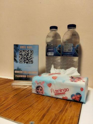 a cake sitting on a table with two bottles of water at Modern Tor Tao camp in Ban Pak Suat