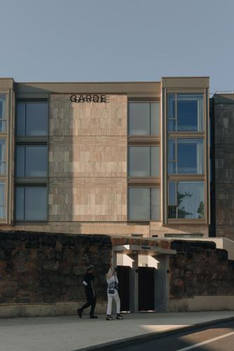 two people walking in front of a building at Garde and Warders Hotel in Fremantle
