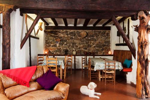 a living room with a couch and a table and chairs at Casa La Sabina Rural in Calomarde